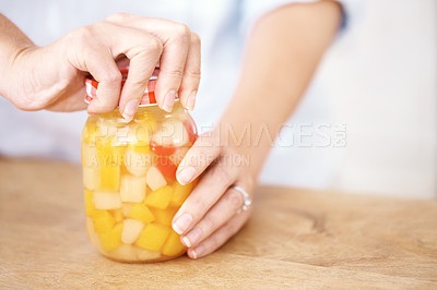 Buy stock photo Cropped image of a woman opening a jar in the kitchen