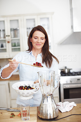 Buy stock photo Blender, kitchen and woman with fruit for smoothie, healthy food, vegan diet and nutrition for wellness. Smile, female person and appliance for berry drink with protein and organic breakfast in home