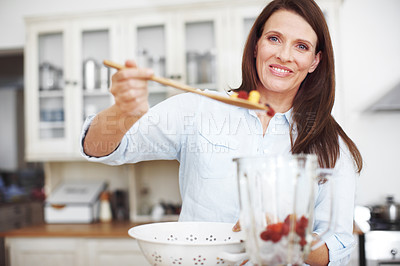 Buy stock photo Kitchen, fruit and woman with blender and spoon, home and smoothie for detox or diet. Portrait, smile or healthy person for meal preparation and organic ingredients, vegan recipe and weight loss meal