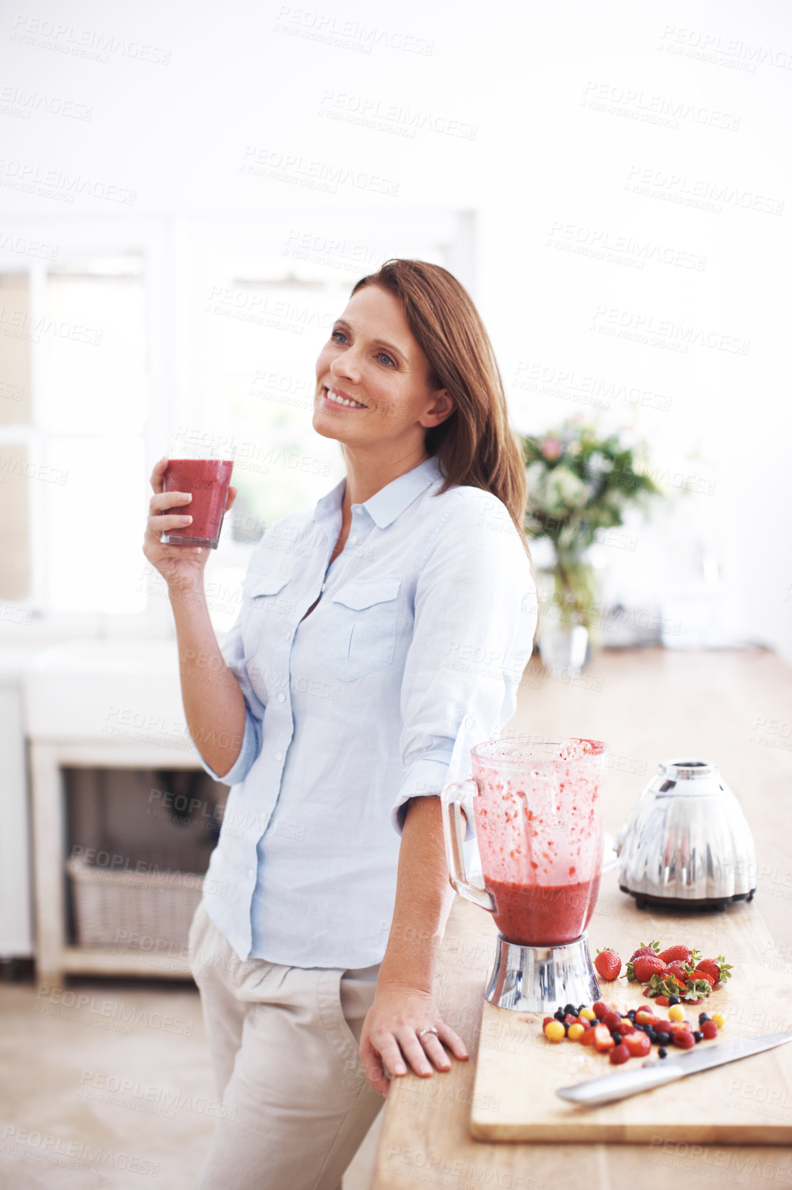 Buy stock photo Woman, drinking and glass in kitchen for smoothie or milkshake, handmade and fruit recipe for breakfast detox diet. Girl, strawberry and home for meal alternative, vitamin boost and natural protein