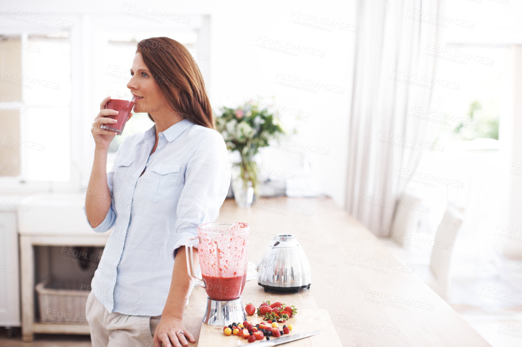 Buy stock photo Woman, drink and glass in kitchen for smoothie or milkshake, handmade and fresh recipe for breakfast detox diet. Girl, strawberry and ideas for meal alternative, vitamin boost and natural nutrition.