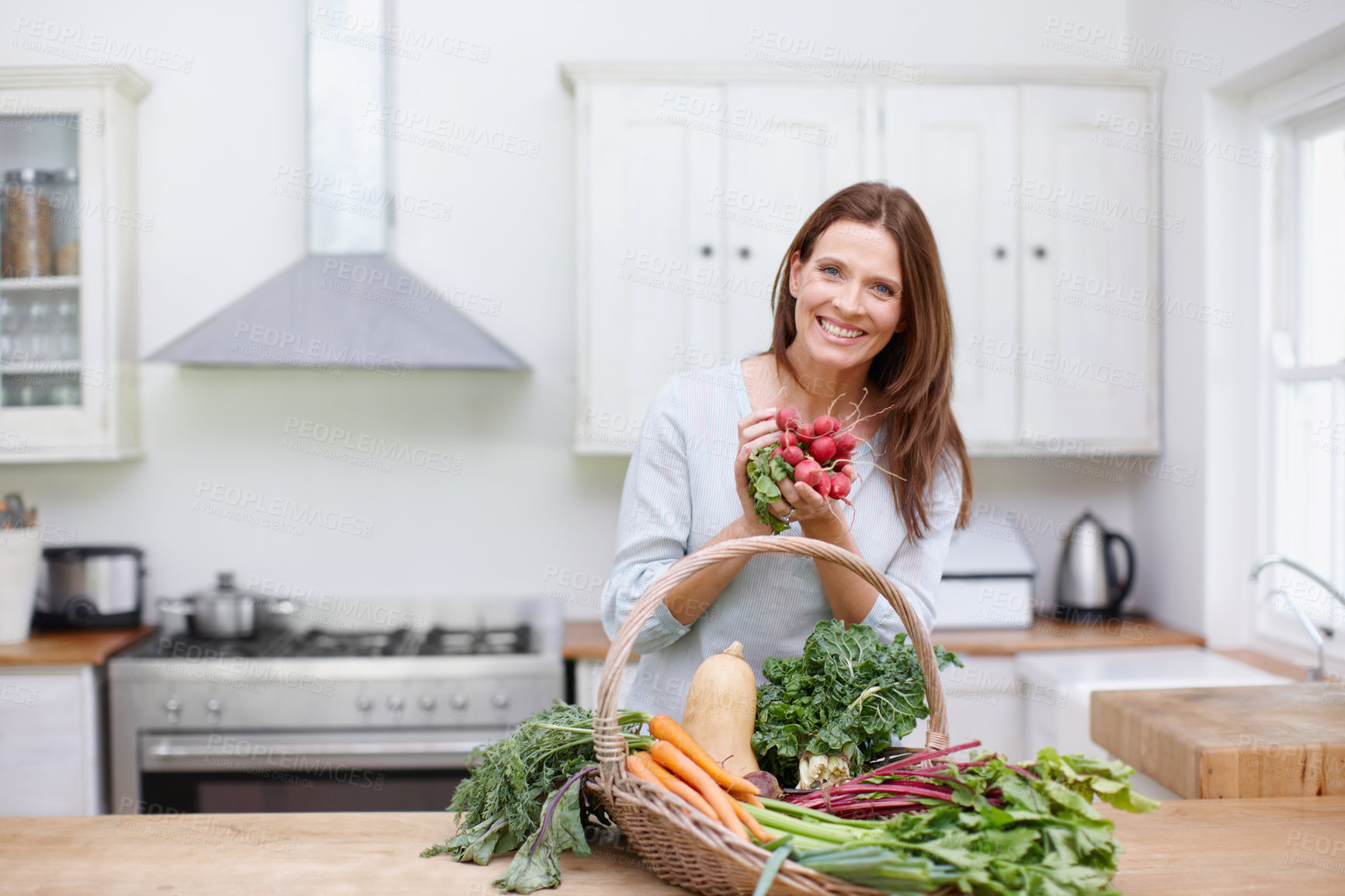 Buy stock photo Portrait, woman and fresh vegetables on kitchen table with gardening, growth and radishes in basket. Female person, gardener and nutrition for diet, healthy eating and sustainability in agriculture