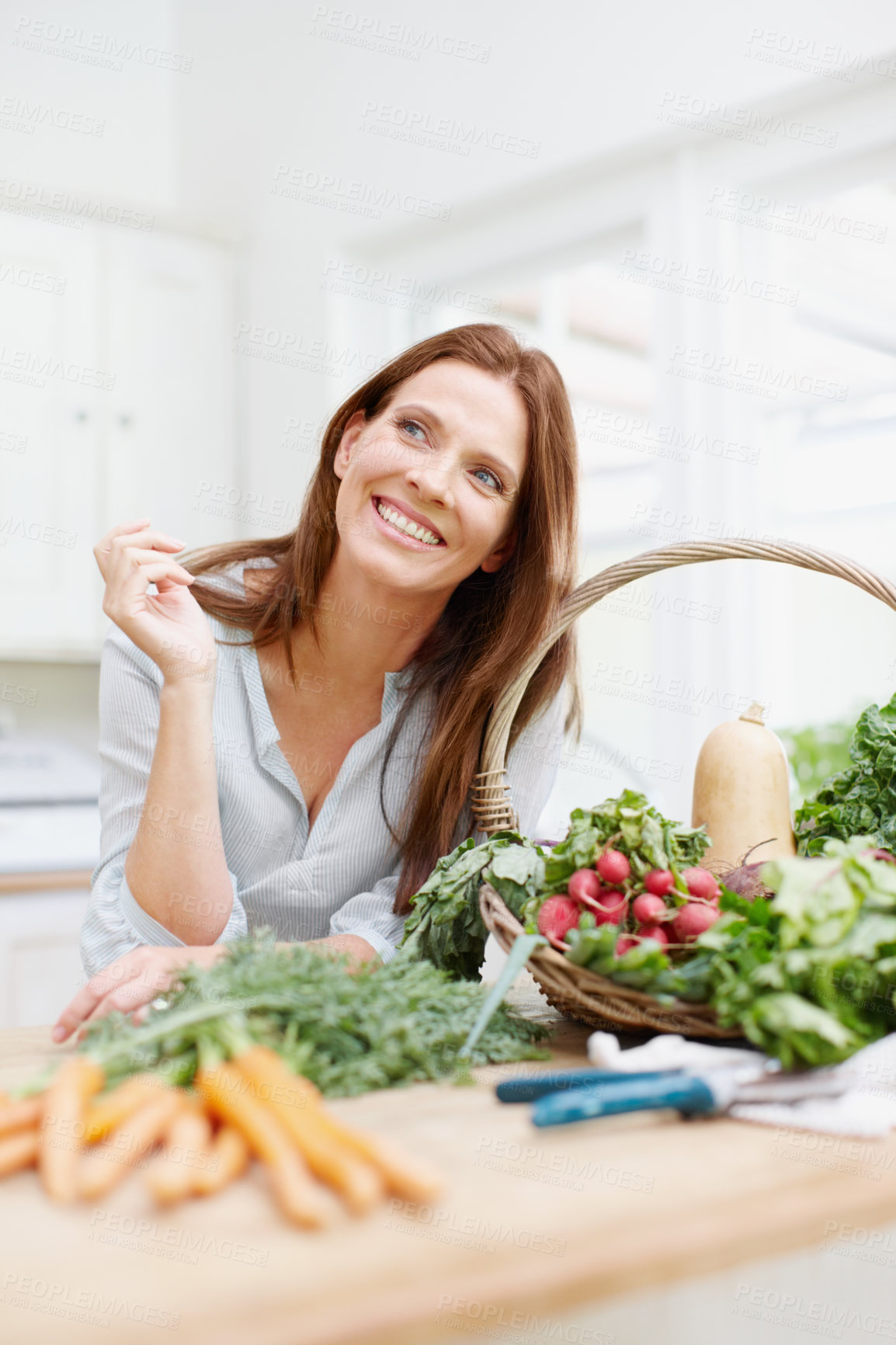 Buy stock photo Thinking, woman and organic vegetables on kitchen table with gardening, home and harvest in basket. Female person, gardener and nutrition for diet, healthy eating and sustainability in agriculture