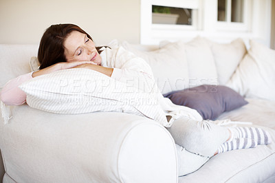 Buy stock photo An attractive woman resting on a sofa indoors