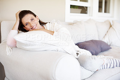 Buy stock photo An attractive woman brunette relaxing on a sofa indoors