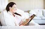 Reading a romance novel on her e-reader