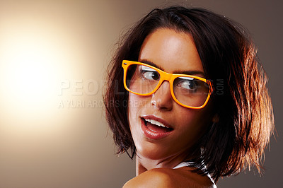 Buy stock photo Woman, face and closeup with glasses in studio for vision, sight and trendy fashion mock up on brown background. Female model, confident or pose for wow, surprise or omg for cool, chic or spectacles 