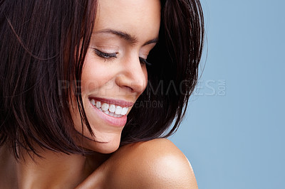 Buy stock photo Closeup of a happy young woman smiling against colored background