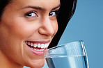 An attractive young woman drinking a glass of water