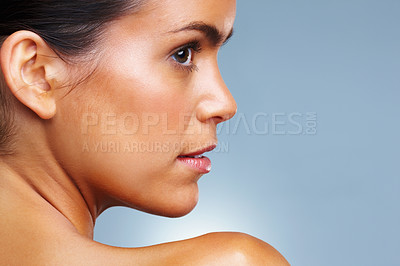 Buy stock photo Side view of a pretty young woman isolated against colored background