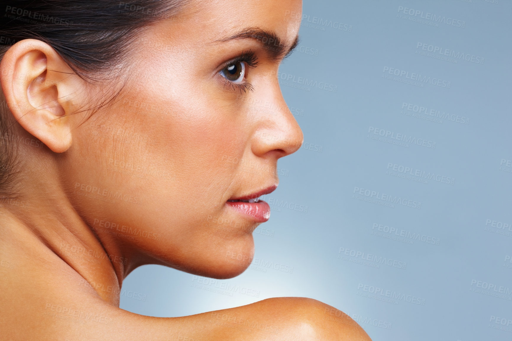 Buy stock photo Side view of a pretty young woman isolated against colored background