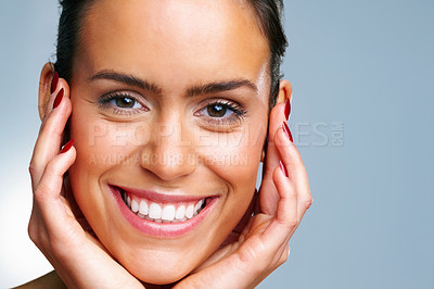 Buy stock photo Detail shot of a cheerful young woman with hands on chin against colored background