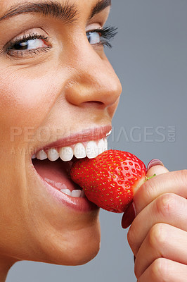 Buy stock photo Detail shot of a cheerful young woman eating fresh strawberry