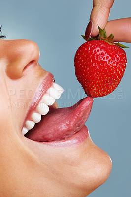 Buy stock photo Detail shot of a seductive woman licking a fresh strawberry