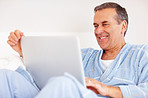 Cheerful mature man  browsing the internet against white