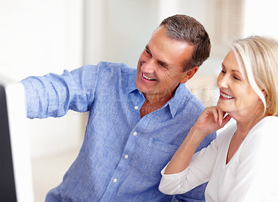 Buy stock photo Talking, senior or happy couple on laptop for email, social media or streaming subscription in home. Research, booking vacation or mature people on computer website or internet network in living room