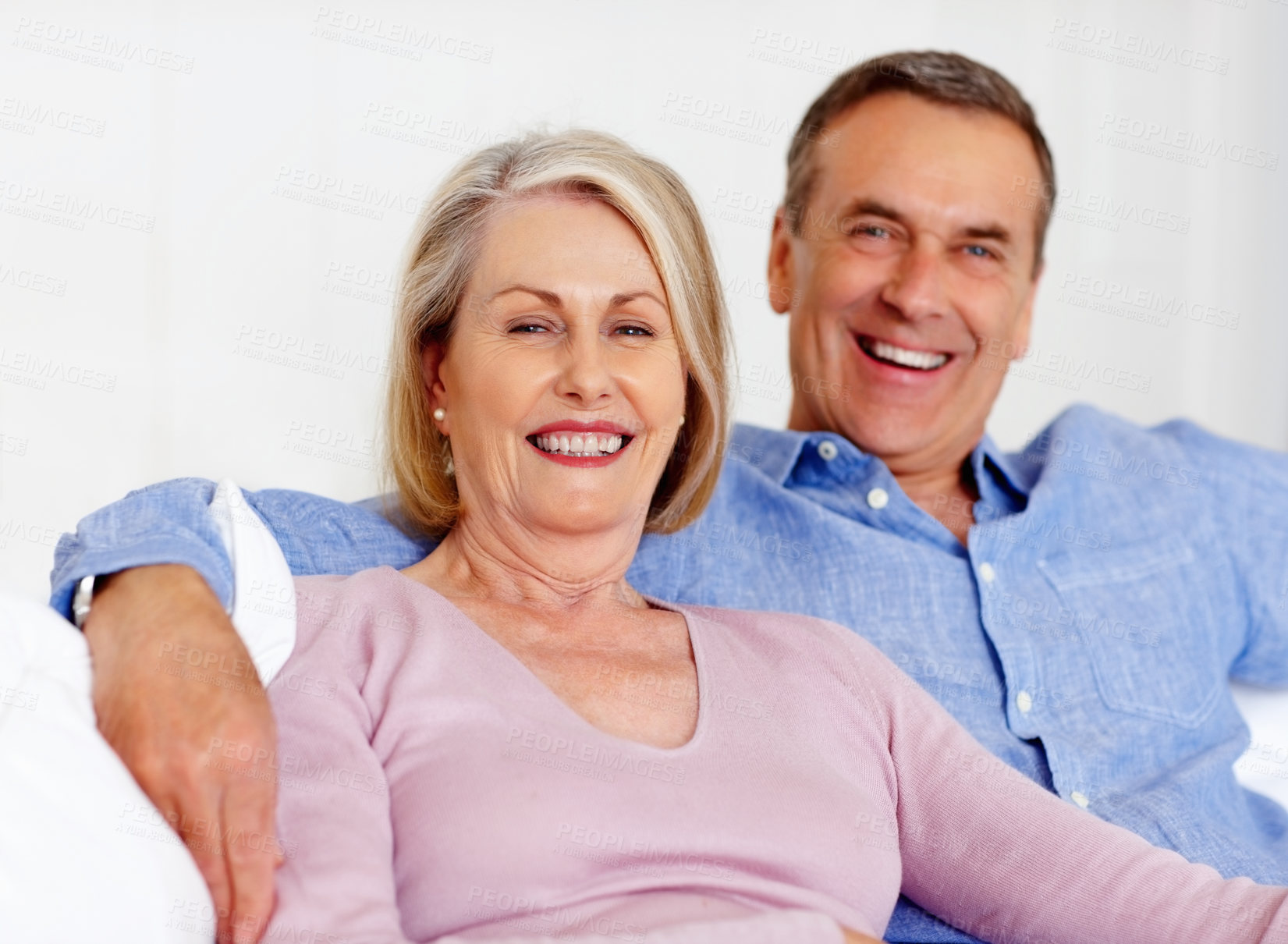 Buy stock photo Elderly, couple and portrait or happy on sofa with support, relationship and marriage in retirement home. Senior, man and woman with smile on couch in living room with trust, care and love in house 