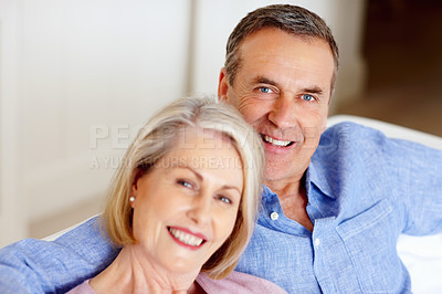 Buy stock photo Smile, portrait or senior couple in home with love on sofa to bond or hug in a marriage commitment together. Happy, face or mature people in retirement with care or support in living room to relax 