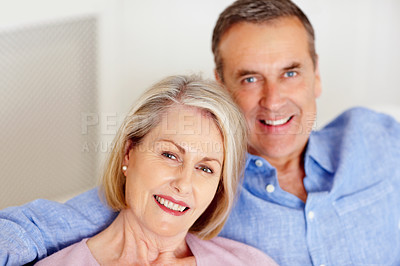 Buy stock photo Senior, couple and portrait or smile on sofa with support, relationship and marriage in retirement home. Elderly, man and woman with happy on couch in living room with trust, care and love in house 