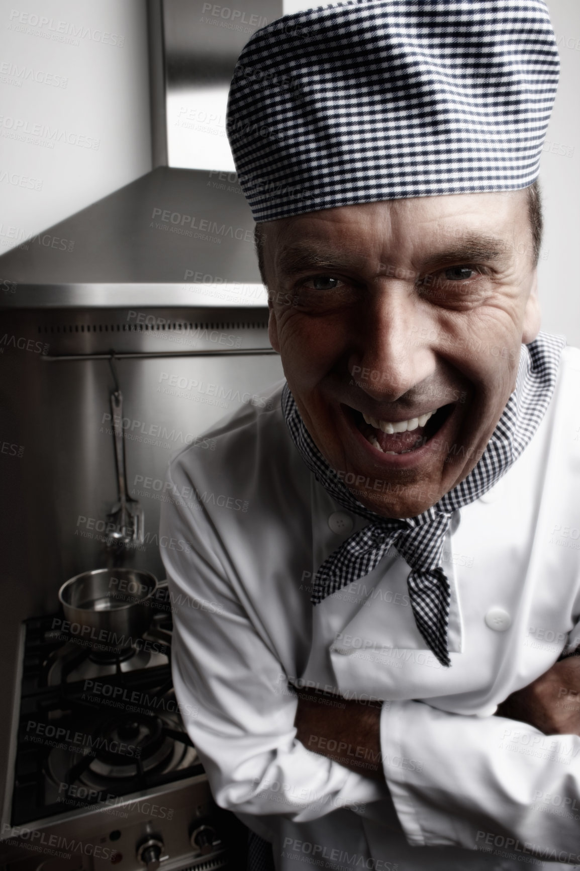 Buy stock photo Man, laughing and chef with arms crossed in kitchen for cooking, hospitality or culinary professional. Mature person, smile and funny joke at hotel restaurant for dinner cuisine, menu or service