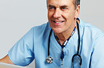 Happy senior doctor with stethoscope against white background