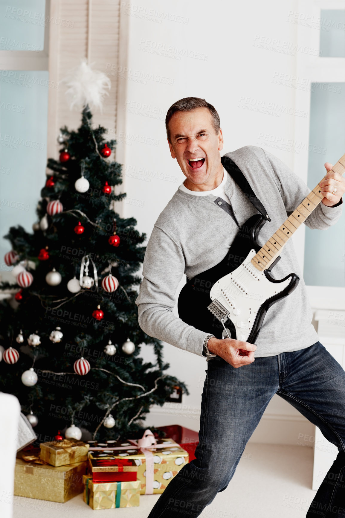 Buy stock photo Mature man, guitar and portrait for Christmas with fun, excited and fun in living room. Male musician, passion and instrument in lounge for music, creativity and celebration with happiness at home