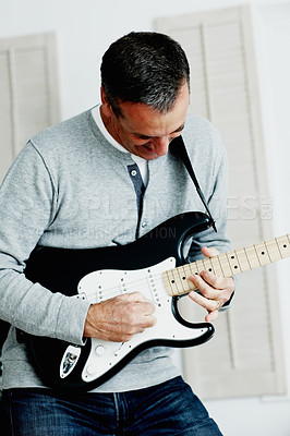 Buy stock photo Man, electric guitar and happy in living room with music, excited and fun at home. Male musician, smile and instrument in lounge for melody, creativity or rock and roll with entertainment in house