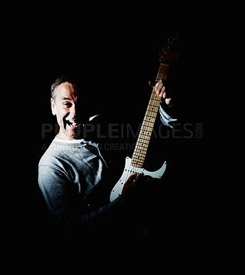 Buy stock photo Mature, guitar or portrait of happy man in studio performance for rock, artist or concert in dark. Black background, creative person and excited musician playing instrument with song or crazy skills