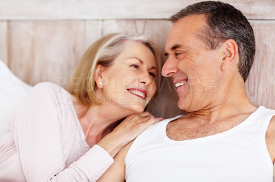 Buy stock photo Closeup portrait of a romantic mature couple looking at each other, smiling