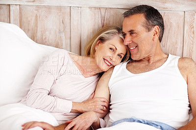 Buy stock photo Portrait of a smiling mature woman resting on husband's shoulder