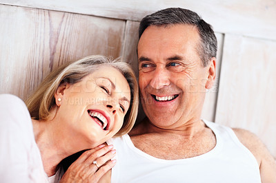 Buy stock photo Mature couple, happy and smile on bed at house for relax, love and retirement together with trust and care. Man, woman and cuddle in hotel bedroom for marriage, loyalty or tired on weekend with hug