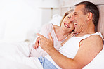 Happy family - Cheerful mature man with wife lying in bed