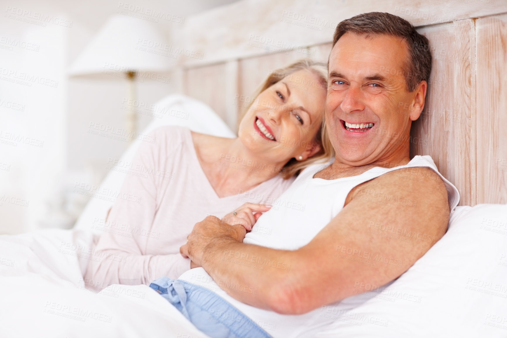 Buy stock photo Mature couple, happy and portrait in bed at house for relax, love and retirement together with trust and care. Man, woman and face in bedroom for marriage, loyalty or support on weekend with smile