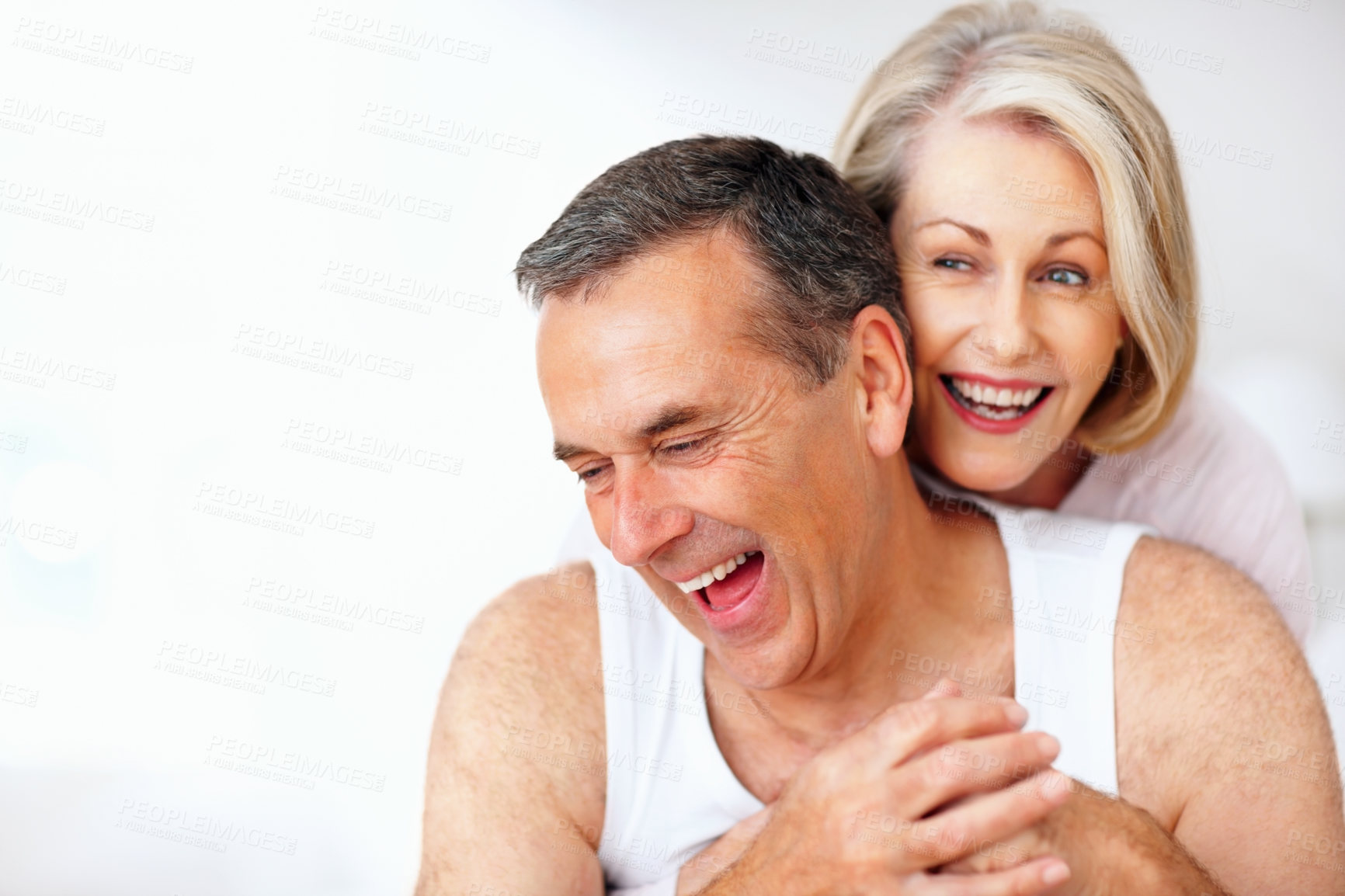 Buy stock photo Senior, funny or happy couple hug in house bedroom together to relax on holiday for bonding or support. Embrace, laughing or romantic man and mature woman with love, smile or care on white background