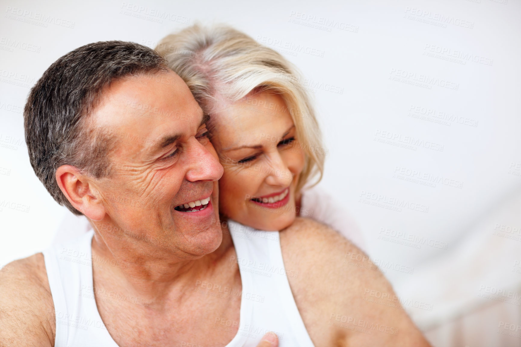 Buy stock photo Closeup of a romantic mature couple spending time together against colored background