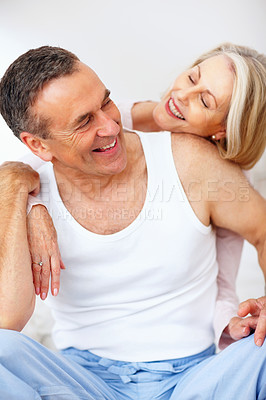 Buy stock photo Mature couple, hug and love in home for support, bonding and bedroom with pyjamas for rest. Embrace, unity or weekend for romance and married man with woman person, relax and cozy in house with smile