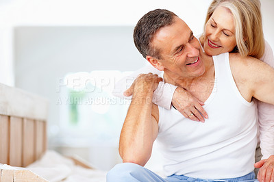 Buy stock photo Mature couple, smile and hug on bed at house for relax, love and retirement together with trust and care. Man, woman and cuddle in hotel bedroom for marriage, loyalty or tired on weekend with happy