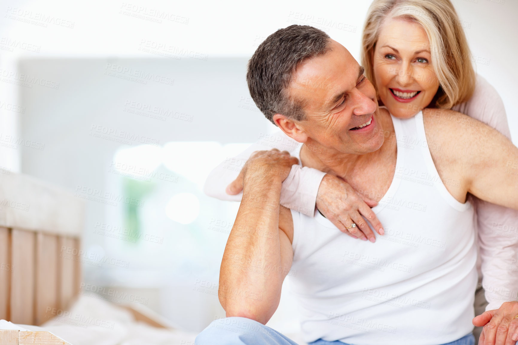 Buy stock photo Mature couple, bonding and hug on bed at house for relax, love and retirement together with trust and care. Man, woman and cuddle in hotel bedroom for marriage, loyalty or tired on weekend with smile