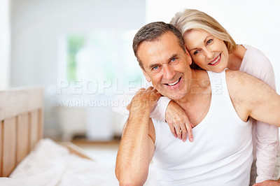 Buy stock photo Senior, happy couple portrait and hug in house bedroom together to relax on holiday for bonding or support. Embrace, retirement and romantic man and mature woman for love, smile or care on home bed