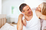 Cheerful mature man and wife having fun together