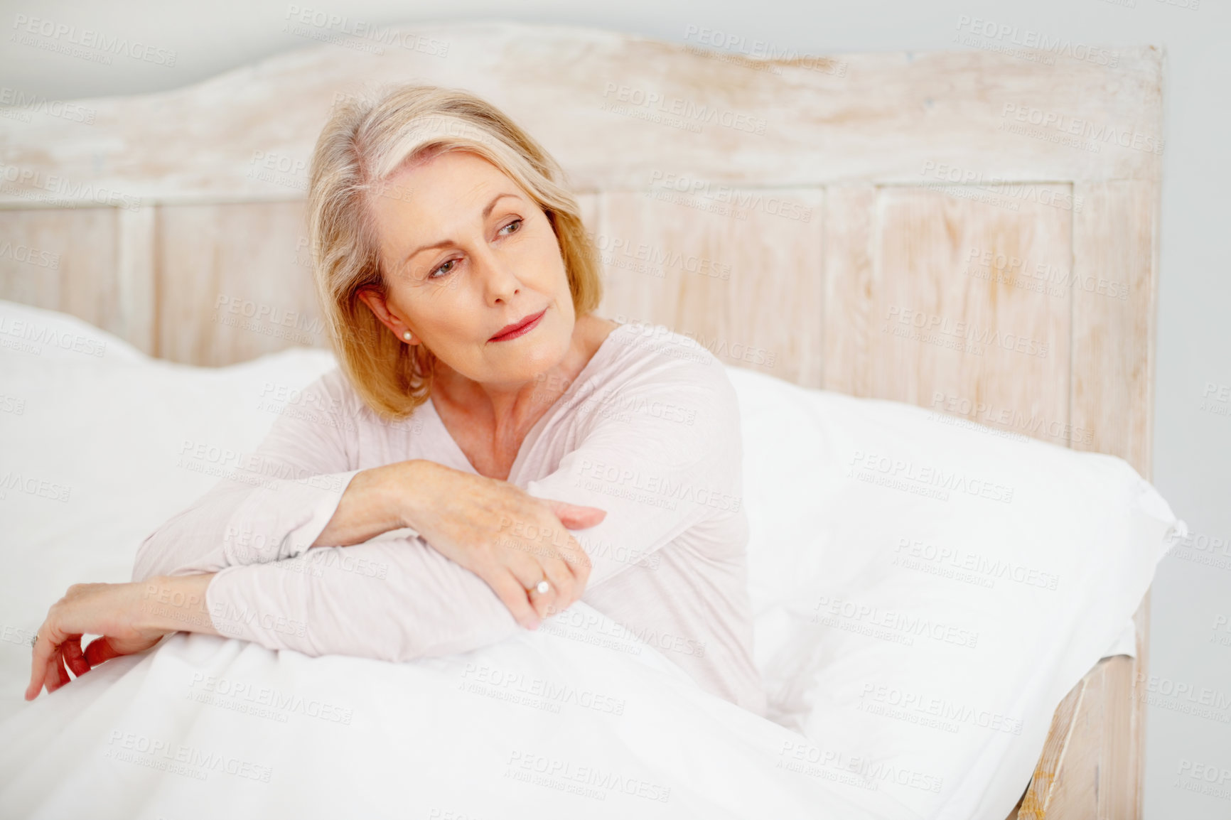 Buy stock photo Senior woman, tired and thinking in bed with mental health, unhappy retirement and insomnia in home. Elderly female person, sad thought and fatigue for burnout, stress and frustrated for sleep crisis