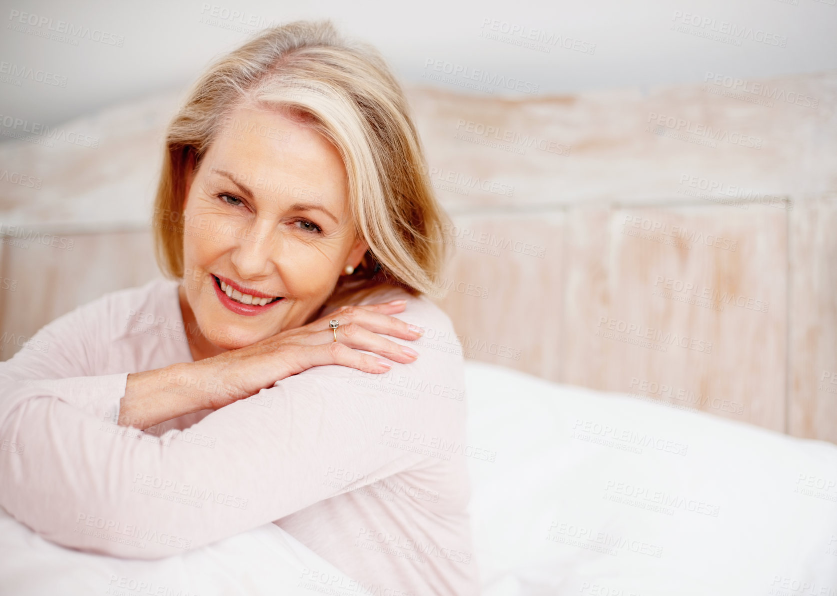 Buy stock photo Senior woman, portrait and relax in bed with mindfulness, happy retirement and weekend in home. Elderly female person, smile and wake up on mattress for morning peace, wellness and pyjama clothes