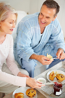 Buy stock photo Portrait of a cheerful mature man and his wife having breakfast