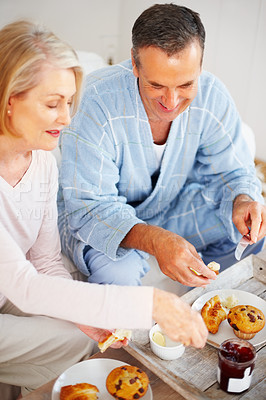 Buy stock photo Elderly couple, bedroom and food for diet, breakfast and wellness for retirement health. Mature woman, man and croissant or muffin with fruit juice for romance, nutrition and senior care or support