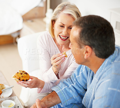 Buy stock photo Senior couple, bedroom and food for support, breakfast and nutrition for retirement health. Mature woman, man and croissant or muffin with fruit jam for diet, romance and elderly wellness or care