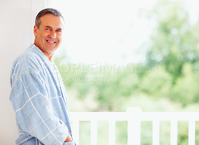 Buy stock photo Senior man, smile and portrait in home with mockup, retirement peace and mindfulness in weekend. Mature male person, happy and wellness with pyjama clothes, calm morning and space for relax.