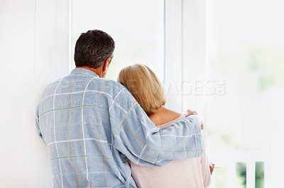 Buy stock photo Rear view of a romantic mature couple looking through glass window