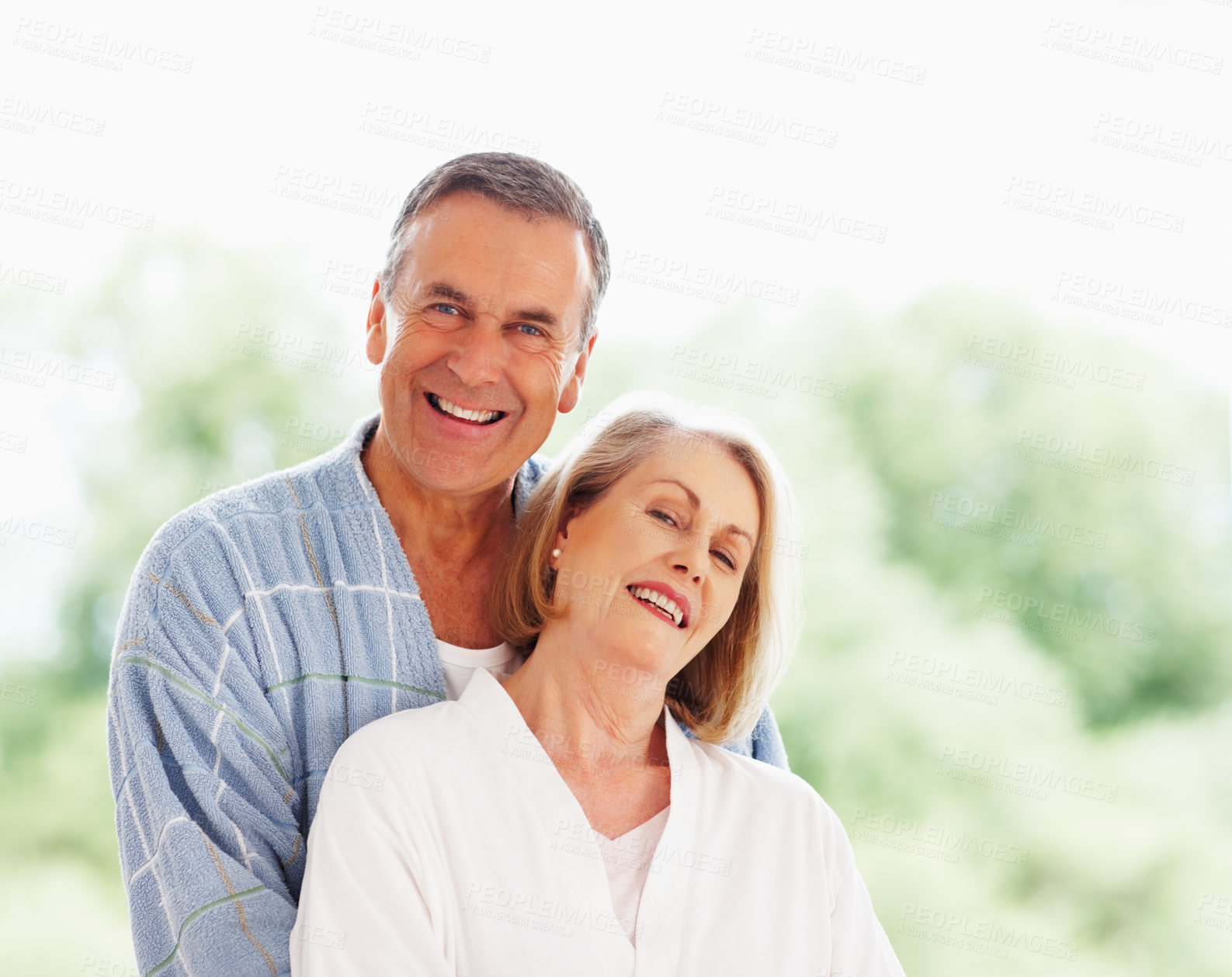 Buy stock photo Portrait, love and window with mature couple, hug and support in living room of house together. Smile, face and trust with happy, senior man and woman bonding while enjoying retirement at home