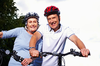 Buy stock photo Mature couple, helmet and bicycle in nature for hobby, portrait or smile on weekend for exercise. Fitness, cardio or bike with safety hands for workout and health, cycling or married people for sport