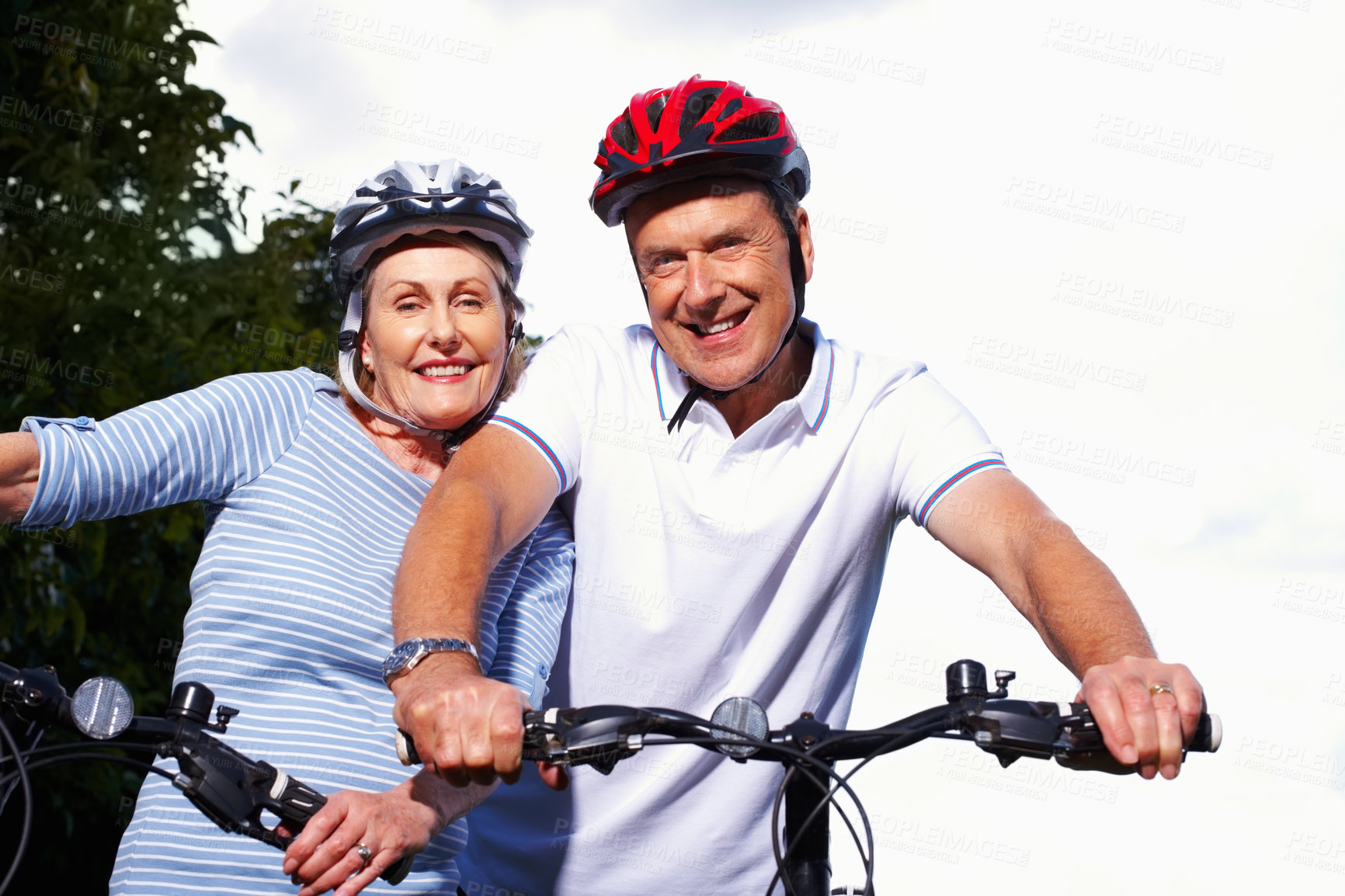 Buy stock photo Mature couple, helmet and bicycle in nature for hobby, portrait or smile on weekend for exercise. Fitness, cardio or bike with safety hands for workout and health, cycling or married people for sport